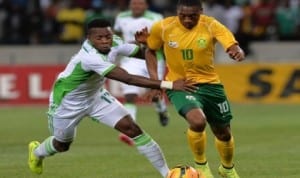 Super Eagles’ midfielder, Ogenyi Onazi (left) struggling to stop Bafana Bafana player during their Africa Cup of Nations qualifier in South Africa on Wednesday