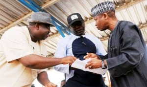 L-R: Chairman, Mangu Local Government Area of Plateau State, Mr Caleb Mutfwang, Plateau Commissioner for Water Resources, Mr Idi Waziri and representative of Minister of Water Resources, Mr Moyi Kabir, going through a document during inspection of Gindiri Dam  recently.