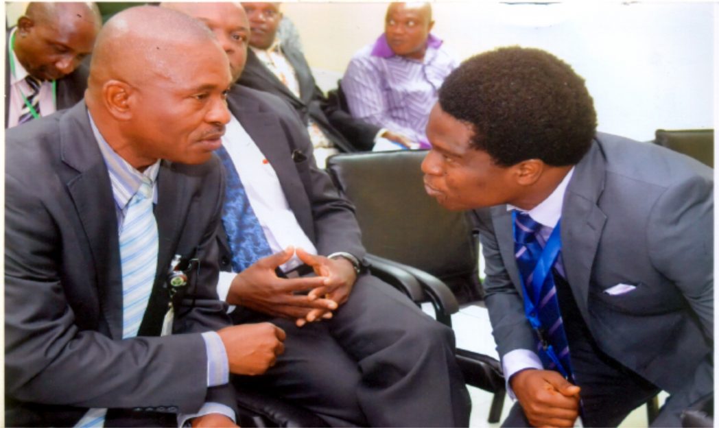 Acting Branch Controller CBN Mr. Emmanuel Etuk, (left), who represented Mr. Ndubisi Jude Ekioebelen Port Harcourt Branch Controller, chatting wth corporate communcation Manager, Mr. Obinali Okoli (rigt) during a workshop on financial inclusion CBN at Port Harcourt branch CBN, recently. Photo: Chris Monyanaga