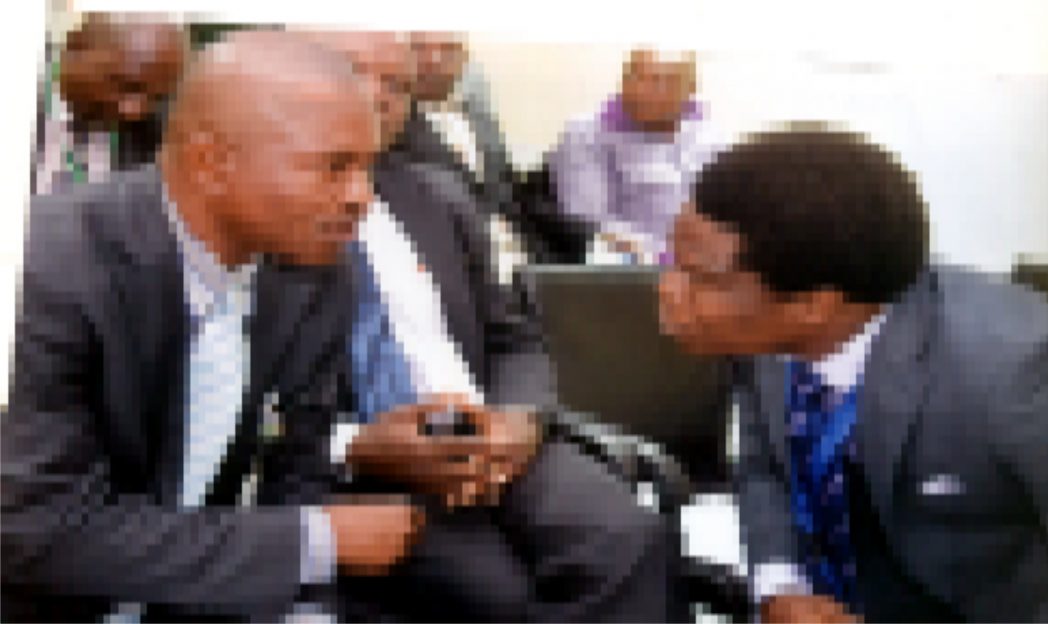 Acting Branch Controller, CBN, Mr Emmanuel Etuk (left) who represented Mr Ndubisi Jude Ekwebelen, Port Harcourt Branch Controller, chatting with Corproate Communciation Manager, Mr Obinali Okoli (right) during a workshop on Financial Inclusion, CBN in Port Harcourt recently. Photo: Chris Monyanaga