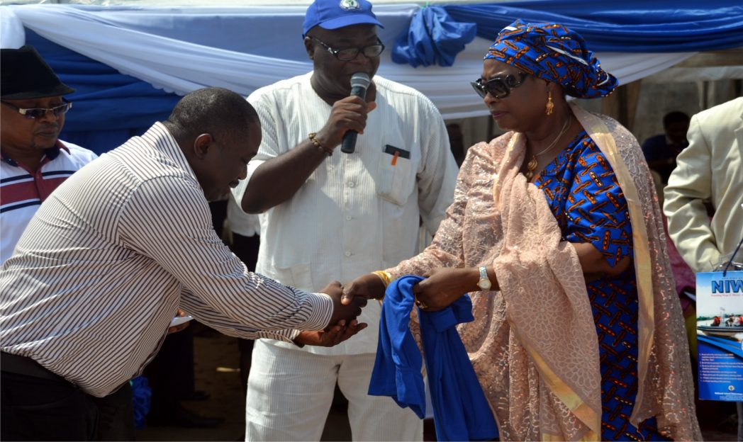 Managing Director, Hajiya Inna Maryam Ciroma (right) congratulating the vice chairman of Maritime Workers Union. Rivers State Council, Comrade Godwin Dominic at the 2014 NIWA safety awareness campaign, at Port Harcourt NIWA Dockyard, Marine Base while General Manager, Corporate Affairs, NIWA, Mr Tayo Fadile (middle) watch. Photo: Nwiueh Donatus Ken