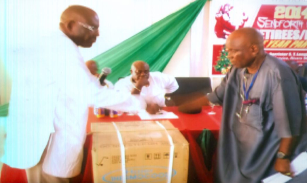 Head of Service, Barr. Samuel LongJohn (left) in a handshake with a retiree after the presentation of refrigerator at a sendforth party for retired staff of his office.