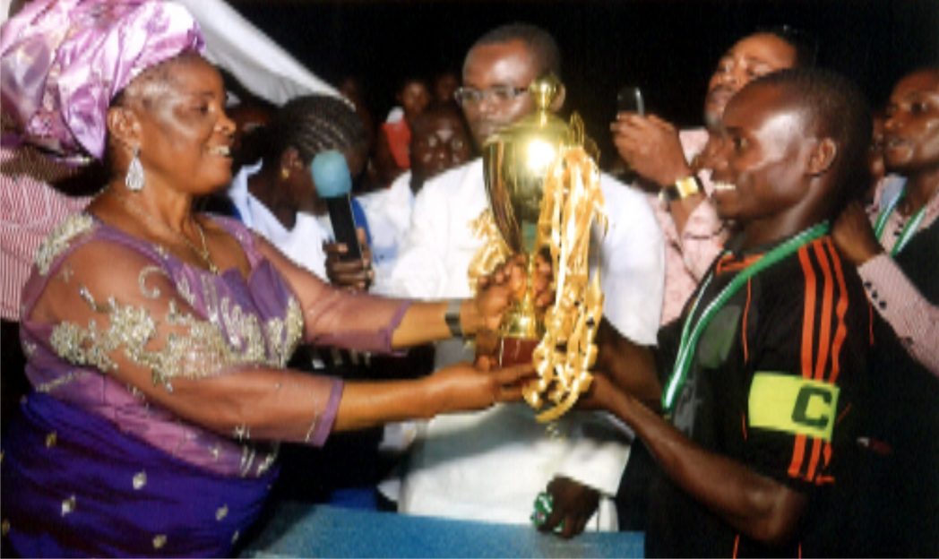 Cup Donor, Hon Felicia Tanen (left) presenting the winners trophy to DCAT FC captain at the end of the 2014 Botem Football tournament in Tai LGA, Rivers State. Photo: Chris Monyanaga
