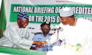 Election and Party Monitoring Committee, Prof. Lai Olorode (left), in handshake with Chairman, Independent National Electoral Commission, Prof. Attahiru Jega, during the national briefing of accredited observers for the 2015 General Election in Abuja, yesterday. With them is the Inspector General of Police, Suleiman Abba.
