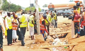 Environmental sanitation workers cleaning the scene of the Nyanya explosion in Abuja recently.