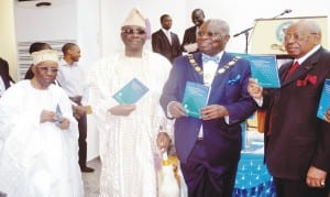 L-R: Founder, Chartered Institute of Bankers of Nigeria, (Cibn), Alhaji Oladimeji Otiti; Oba of Lagos, Obarilwan Akiolu; President, Cibn, Dr Sina Aina and Chairman, First  City Monument Bank, Otunba Micheal Balogun, during the Unveiling of  a Book Titled "The Economy of Financial Inclusion in Nigeria" written by Dr Aina in Lagos recently.