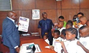 Group News Editor of The Tide Newspaper, Mr. Nelson Chukwudi (left), displaying a copy of the paper while explaining a point to pupils of Noble Giant International School, Igwuruta, during an excursion visit to The Tide office in Port Harcourt, last Thursday.   Photo: Iboioye Diama