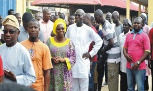 Governor Babatunde Fashola of Lagos State (4th left), his wife Abimbola (3rd left) and other  voters queue for accreditation at Itolo Ward 003, Surulere, Lagos  last Saturday 