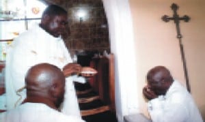 Prof. Godwin Tasie (right), receiving Holy Sacrement, during the Easter Sunday celebration at St Andrew’s Anglican Church, Bakana last Sunday. With him are the Vicar, Rev Canon I. Amabibi (left) and a communicant Photo: Egberi A. Sampson