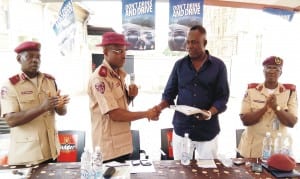 FRSC Anambra State Sector Commander, Mr Sunday Ajayi (middle), presenting safety tip materials to the Chief Executive Officer, Trigpoint Hotels, Chief Felix Ogbuefi (right), in Awka last Thursday. With them are the Head, Training Department, Mr Olusegun Akinola (left) and Head, Public Education, Mrs Chinelo Ezekwesili. Photo: NAN