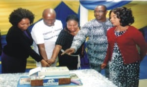 Retired Business Development Manager, Port Harcourt Area Office, First Bank (NIG) Limited, Mr Orlu D.Tasie (2and left) joined with others staff of the Bank to cut the celebration cake to mark retirement of the manager during a send forth party, recently