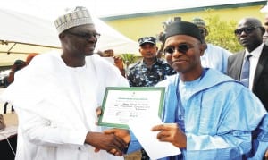 Independent National Electoral Commissioner, Dr Chris Iyimoga (left) presenting Certificate of Return to governor-elect, Malam Nasir El-Rufai in Kaduna, on Wednesday.