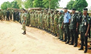 Officers and men taking instructions from the commander of Onitsha Military Cantonment, Col. Mohammed Bello, during a joint security task force on State-Wide show-of-force on Onitsha-Enugu Road , recently