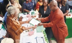 Representative of the chairman of INEC and National Commissioner in charge of Akwa-Ibom, Cross River and Rivers States, Barr Thelma Iremiren (left) presenting certificate of return to the Governor-elect of Rivers State, Barr Nyesom Wike( right) during the presentation of certificate of return to the winners of March 28 and April 11, 2015 election at INEC office in Port Harcourt, Monday. Photo Chris Monyanaga
