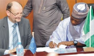 Minister of National Planning, Dr Abubakar Sulaiman (right), signing financial agreement for the 11th European Development Fund Support to strengthen community-based psychosocial and protection services for children and adolescents in Borno, in Abuja, recently. With him is the head, European delegation, Mr  Michel Arrion.