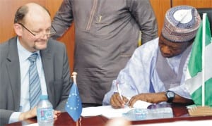 Minister of National Planning, Dr Abubakar Sulaiman (right), signing financial agreement for the 11th European Development Fund Support to strengthen community-based psychosocial and protection services for children and adolescents in Borno, in Abuja, recently. With him is the head, European delegation, Mr Michel Arrion.