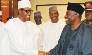 President-elect, Gen. Muhammadu Buhari (left) in a handshake with President Goodluck Jonathan, during his official visit to the Presidential Villa in Abuja last Friday .With them is the former Chief of Army Staff, Lt.-Gen. Abduhraman Dambazau.