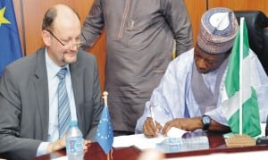 Minister of National Planning, Dr Abubakar Sulaiman (right), signing financial agreement for the 11th European Development Fund Support to strengthen community-based psychosocial and protection services for children and adolescents in Borno State, in Abuja recently. With him is the Head, European Delegation, Mr  Michel Arrion.