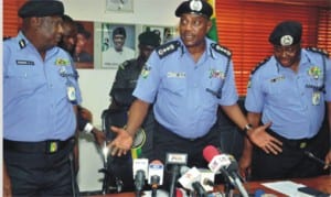 Inspector General of Police Solomon Arase (middle) with other top police officers, addressing newsmen over the arrest of 98 suspects involved in cult activities in Edo State, recently .