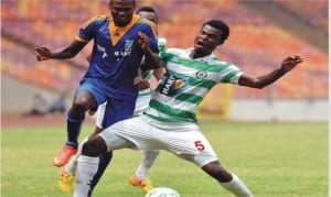 Dolphins FC’s player (5) trying to stop an opponent in a 2015 Glo Premier League encounter at the Liberation Stadium, Port Harcourt, recently.