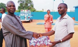 The frsc Unit Commander in Nteje, Mr Alkassim Mustapha (left), presenting a gift to the overall best officer of the Unit Command in 2014, Mr Agwu Dickson,the Acting Head of Operations of the Unit Command in Anambra State, recently.