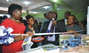 Dr Godwin Okon (centre) cutting the tape to commissioned the Goss Rotary Machine of The Tide Newspaper Corporation. He is assisted by Commissioner for Information and Communications, Mrs Ibim Semenitari (left), and the General Manager, Rivers State Newspaper Corporation, Mr Celestine Ogolo in Port Harcourt, yesterday.Inset is the newRotary Machine