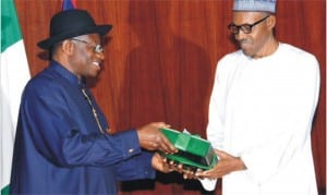 Outgoing President, Goodluck Jonathan submitting his handover notes to President-elect, Muhammdu Buhari at the Presidential Villa, Abuja yesterday