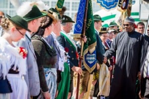 President Muhammadu Buhari (right), inspecting a guard of honour on his arrival in Germany, yesterday