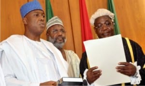 Clerk of the National Assembly, Salisu Maikasuwa (right) swearinng-in the Senate President, Bukola Saraki at the inauguration of the 8th National Assembly in Abuja, yesterday 