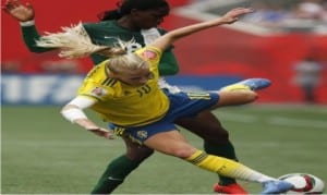 Sweden’s Sofia Jakobsson (10) knocked off the ball by Nigeria’s Asisat Oshoala (8) during the first half of a FIFA Women’s World Cup soccer match in Winnipeg, Manitoba, Monday, June 8, 2015. 