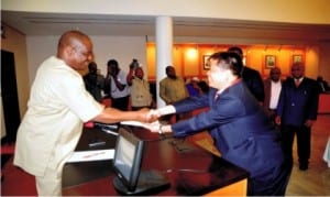 Governor Nyesom Wike of Rivers State (left), handing a copy of the MOU between Rivers State Government and CCECCC to Qingyoang (2nd right), at Govenment House, Port Harcourt, recently.
