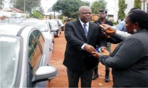 Chief  Judge of  Anambra State, Justice Peter Umeadi (Left),  presenting a car key to the Chief  Registrar,  State Judiciary, Mrs Doris Ezeani, symbolising the presentation of  cars to 20  newly appointed magistrates and two other staff of the State judiciary in Awka on Monday 