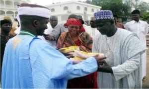 Senator Abdul-Aziz Nyako of Adamawa Central Senatorial District (left), distributing improved maize seedlings to farmers in  Yola, recently.   Photo: NAN