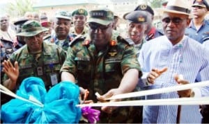 Chief of Defence Staff,  Air Chief Marshal Alex Badeh (middle), cutting a tape to inaugurate the permanent site of the Joint Task Force  (JTF), Operation Pulo Shield in the Niger Delta, recently. With him are: JTF  Commander, Maj.-Gen. Emmanuel Atewe (left) and Deputy Governor of Bayelsa State, Retired Rear Adm. John Jonah (right).