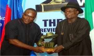 Funding Director, Ijaw Council for Human Rights, Mr Patterson Ogon (left), presenting heroes award to Chairman of the occasion, Retired Rear Admiral Ocheago Fingesi during the Rivers Ijaw Youths heroes award in Port Harcourt last Friday