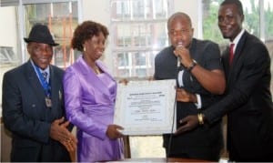 L-R: Administrative Secretary, Independent National Electoral Commission, Rivers State , Mr Roy Obijuru, the Resident Electoral Commissioner (REC), Dame Gesila Khan, President, New Rivers Vision Students (NRVS), Mr Chimzi Ihunwo and Publicity Secretary of NRVS, Mr Kelvin Mopho, at the presentation of  a Meritorious Award to the REC by NRVS in Port Harcourt, yesterday