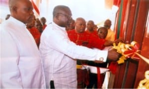 The Chairman of the occasion, Mr. Tamuno Ajubo Atamuno cutting the tape to declare the speed boat house open at Okrika ATC while Rev Iyolobia Tamunokonbia and members of the association watch, recently.