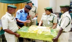 Akwa Ibom State Commissioner of Police, Mr Gabriel Achong, making a presention to the Controller of Prisons, Dr Regina Akpan during his visit to the prisons controller in Uyo, recently.        Photo: NAN