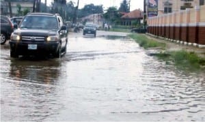 Cars wading through a flooded  street in Port Harcourt recently