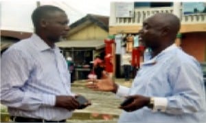 Director, Cabinet Office of the SSG,, Mr. Hamilton Amadi (left), conferring with his brother, Chief Rogers Amadi, during the funeral service of their mother at First Baplist Church in Ogbogoro community last SaturdayPhoto: Chris Monyanaga
