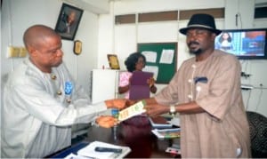 Federal Commissioner, Public Complaints Commission, Rivers State, Dr Alpheus Paul-Worika (right),  presenting a souvenir to Rivers State Director, National Orientation Agency (NOA), Mr Oliver Wolugbom, during a courtesy visit to the agency in Port Harcourt on Wednesday. Ibioye Diama