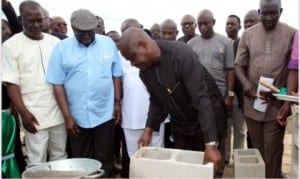 Rivers State Governor, Chief Nyesom Wike (2nd right), laying the foundation of the Motor Spare Parts Dealers ultra modern market, with the Board Chairman, Greater Port Harcourt, Chief Ferdinand Alabaraba (left) and Mr Maxwell Anuonye, Chairman SPAT Limited (extreme left).