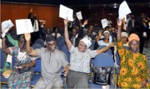 Shareholders voting at the extraordinary general meeting of Stanbic IBTC in Abuja, yesterday.