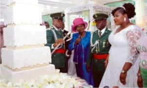 Rivers State Deputy Governor, Dr. Ipalibo Harry- Banigo (2nd left), supervising the cutting of wedding cake of the newly wedded couple, Lt and Mrs. Bonaventure Obonyano, during the wedding reception in Port Harcourt on Saturday
