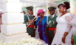 Rivers State Deputy Governor, Dr. Ipalibo Harry- Banigo (2nd left),  supervising the cutting of wedding cake of the newly wedded couple, Lt and Mrs. Bonaventure Obonyano, during the wedding reception in Port Harcourt on Saturday