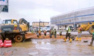 Road construction workers fixing a bad spot along Ikwerre Road, Port Harcourt opposite Rivers State Newspaper Corporation office 