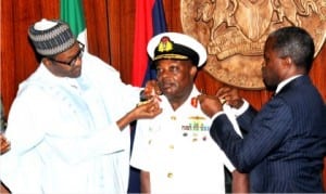 President Muhammadu Buhari (left),  aided by Vice-President Yemi Osinbajo  decorating Chief of Naval  Staff, Ibok Ete Ekwe  Ibas with his new rank of Vice-Admiral, at the Presidential Villa in Abuja,  yesterday