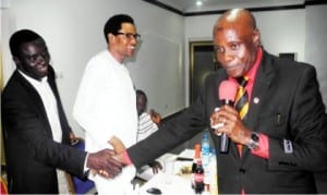 Comptroller of Immigration in Imo State, Mr Abba Idu (left), in a hanshake with the Director, Religious Affairs to Governor Rochas Okorocha of Imo State, during a prayer summit to celebrate the successful conduct of 2015 general elections in Oweri on Saturday. With them is the Director of Protocol, Imo State Government House Chapel, Mr Jerry Okosun.