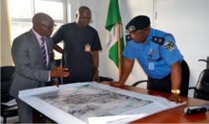Surveyor- General, Rivers State, Mr Noel Elenwo (left), explaining the Port Harcourt masterplan  to former Commissioner of Police, Rivers State, Mr Chris Ezike, during the working visit of Nigeria Institution of Surveyors, Rivers State branch to the State Police command  in Port Harcourt on Wednesday. With them is Mr. Hebron Wisdom              Photo: Nwiueh Donatus Ken