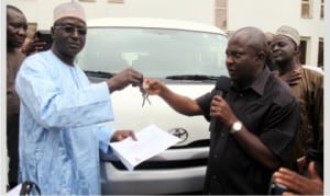 Chief of Staff, Government House,Port Harcourt, Engr Emeka Woke (right), handing over key of a brand new Toyata Haice bus to the National President, Sports Writers Association of Nigeria, Seidu Abubakar, during the association’s 2015 National Full Council Meeting in Port Harcourt, yesterday.